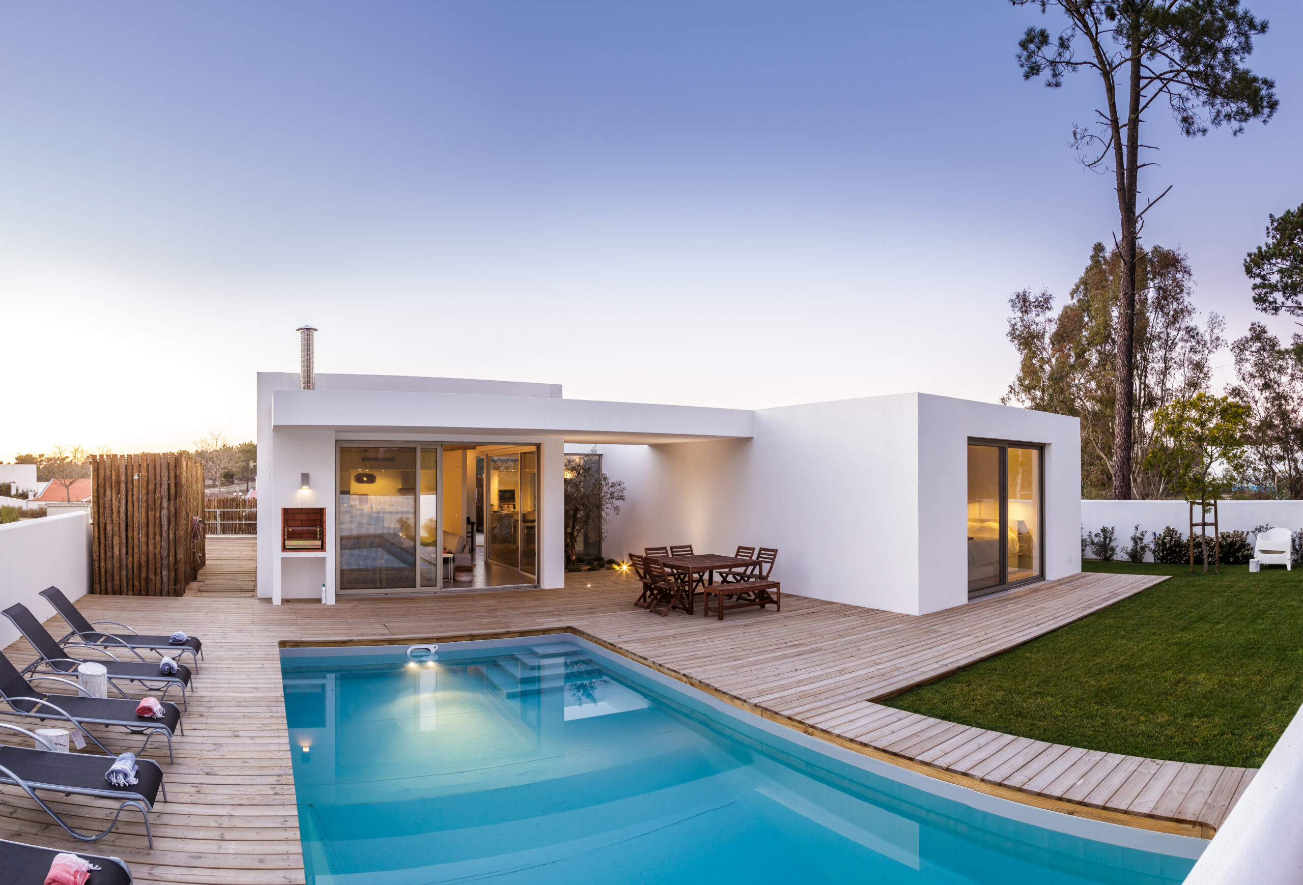 Modern house with garden swimming pool and wooden deck